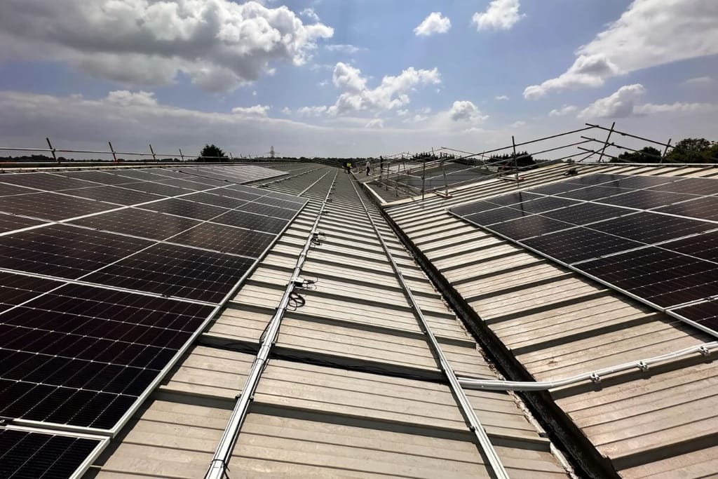 Solar panels on a large building roof, representative installation image